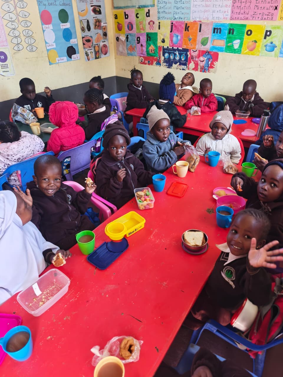 Young learners sharing a meal together in their classroom